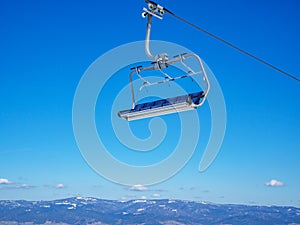 Empty chairlift on blue sky