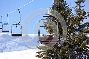 Empty chairlift at mountain ski resort. Winter