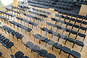 Empty chairs in the assembly hall are arranged in rows, top view