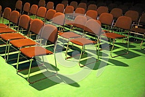 Empty chairs of an auditorium in a congress hall in row