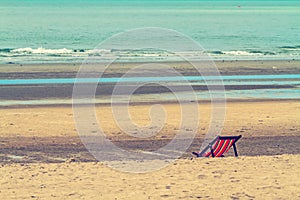Empty chairs on the beach for relax processed in vintage style
