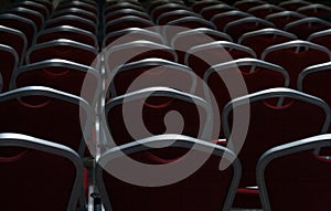 Empty chairs in a dark conference hall