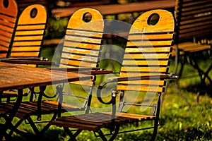 Empty chairs and desks of a garden restaurant