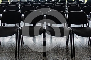 Empty chairs in the foyer of a hall