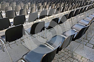 Empty chairs in front of the stage. Preparing for the concert.