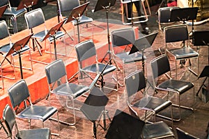 Empty chairs on a stage in concert theater