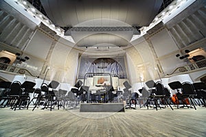 Empty chairs stand on stage