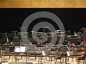 Empty chairs stand on stage in concert hall