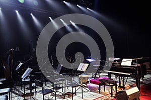 Empty chairs stand on stage in Concert Hall. Piano on stage. Scene symphony concert hall.European scene, a concert of symphonic m