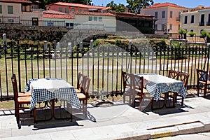 Empty chairs and tables of a traditional restaurant in the touristic district of Plaka