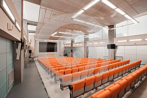 Empty chairs in theatre or conference hall. Orange color