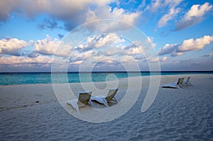 Empty chaise lounge before ocean