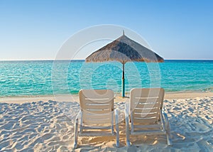 Empty chaise lounge before ocean