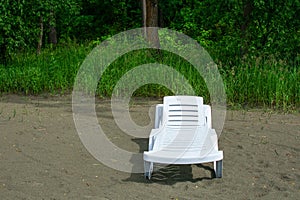 Empty chaise lounge on the sand