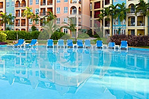 Empty chaise lounges near pool