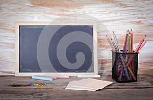 Empty chalkboard background. Old wooden table with texture