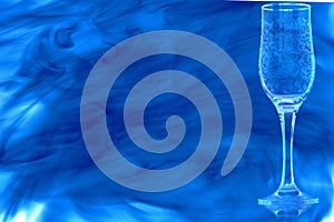 Empty champagne flute enveloped in blue smoke.