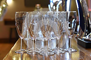 Empty champagne flutes on a bar