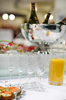 Empty champagne glasses and finger food on festive wedding table