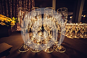 Empty champagne glasses in row on evening event party waiting for the guests.