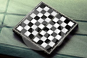 Empty chess board on green on the table