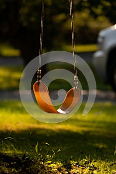 Empty child`s swing in front yard