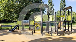 Empty children playground with slide and climbing bars activities in public green park modern
