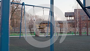 Empty children playground in square park in the center of city during quarantine by reason of coronavirus covid-19 virus