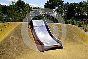 Empty children playground with steel dune slide activities in public kid child park modern