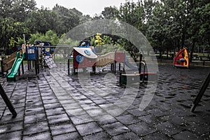 Empty children`s playground during a rainy summer day