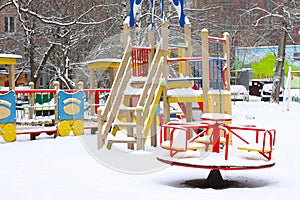 Empty children`s playground in snow