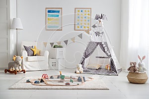 Empty children`s playroom with tent and toy railway