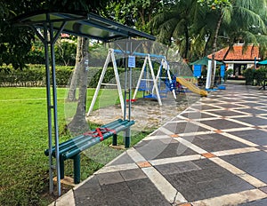 An empty childrens playground with social distancing red crosses