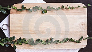 Empty chopping board with herbs flat lay background