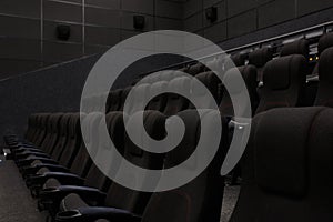 Empty cinema hall with black seats. Movie theatre nobody