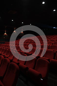 Empty cinema hall with red seats. Movie theatre.