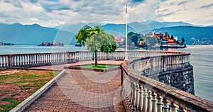 Empty city park in Stresa town. Wonderful summer susnset on Maggiore lake with Bella island on background, Province of Verbano-Cus