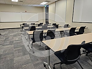 Empty classroom interior, with rows of desks