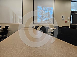 Empty classroom interior, with rows of desks