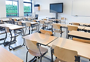 Empty classroom with tables and chairs photo