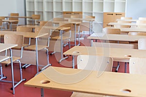 Empty classroom with wooden desks and chairs