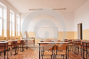 Empty classroom with wooden desks