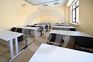Empty classroom with wooden school desks