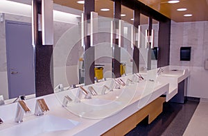 Empty, clean Airport bathroom with many sinks