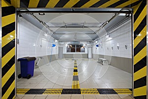 Empty clean car wash room with drainage device and photo