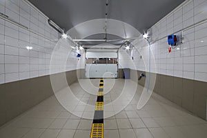 Empty clean car wash room with drainage device and photo