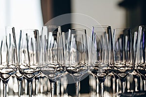 Empty clean champagne glasses on counter in bar.