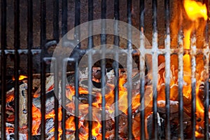 Empty Clean Charcoal BBQ Grill With Vibrant Flames On The Black Background. Cookout Concept.