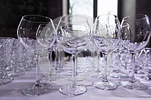 Empty clean drinking wine glasses. Row of empty wine glasses on bar counter