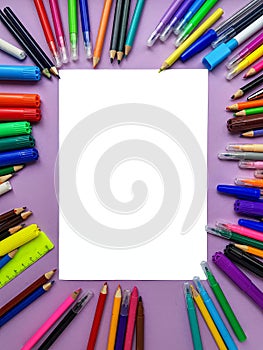 Empty clean white sheet for the buyer`s text on the purple background and school supplies, pencils. Back to school.